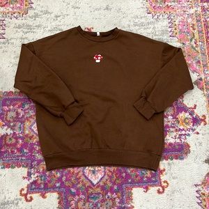 BROWN SWEATSHIRT WITH MUSHROOM ON THE FRONT